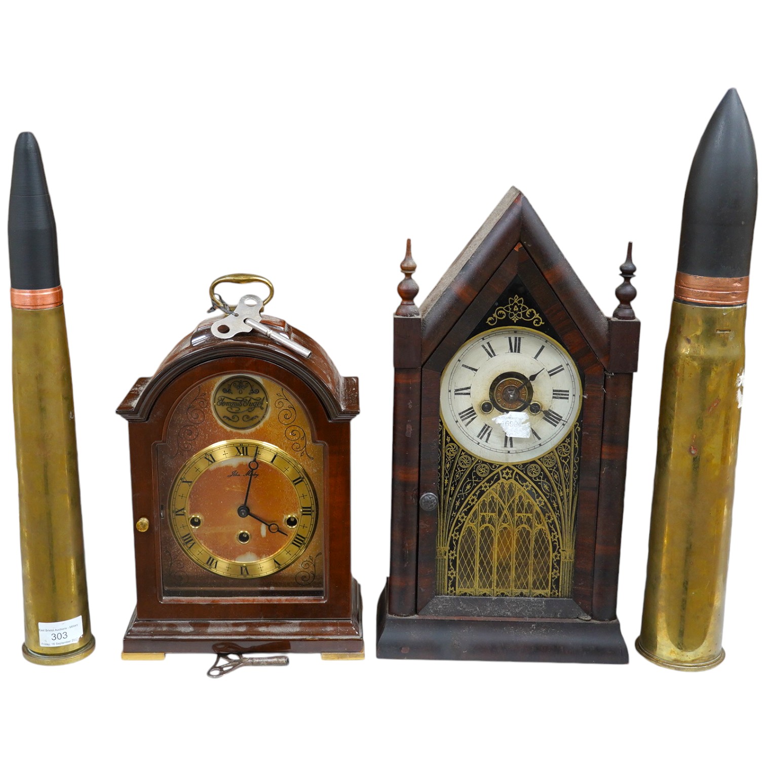 Two clocks including an American example, with keys and two military interest brass shells. Condition - fair